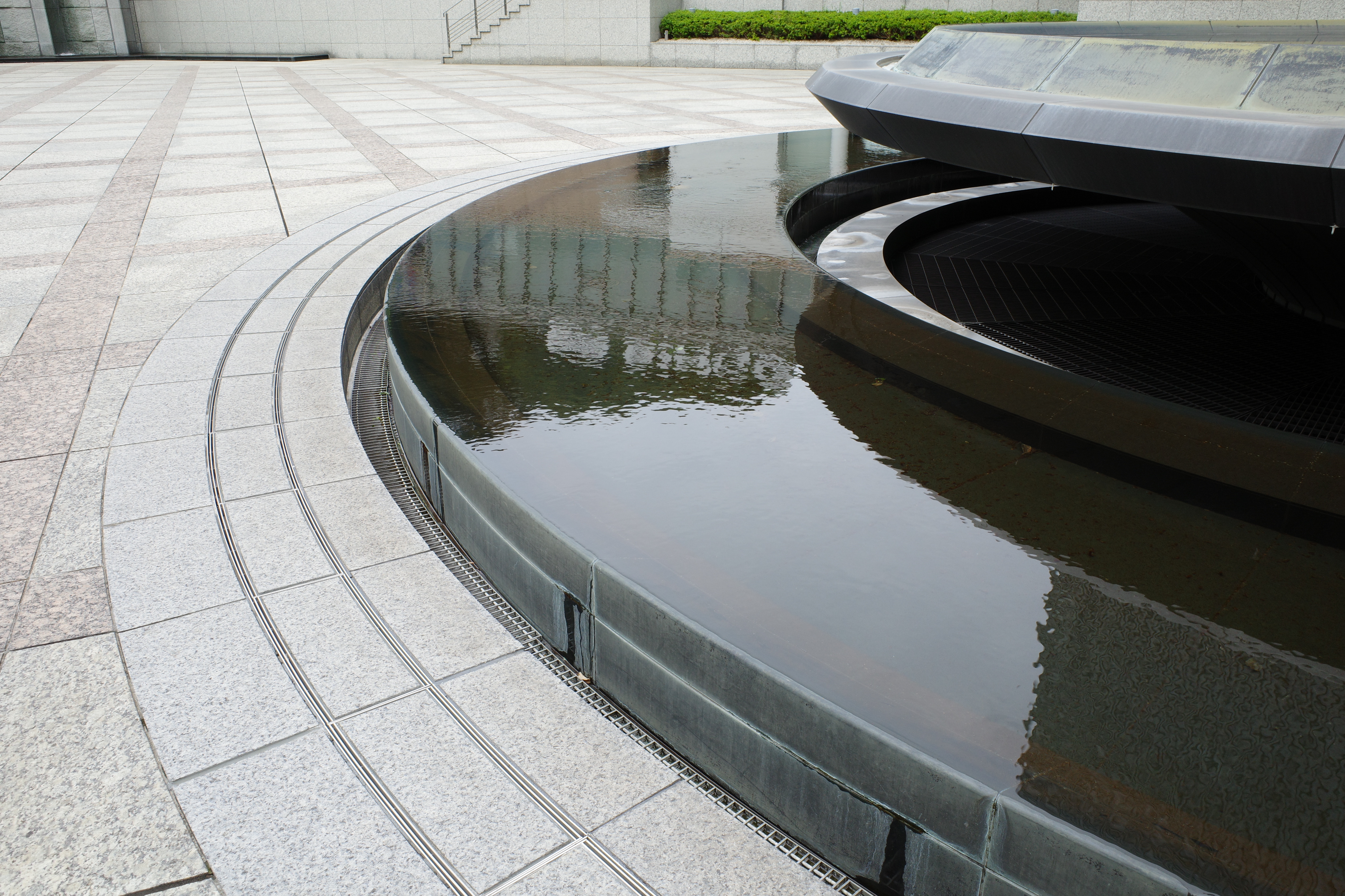 An image of a water fountain made of black stone